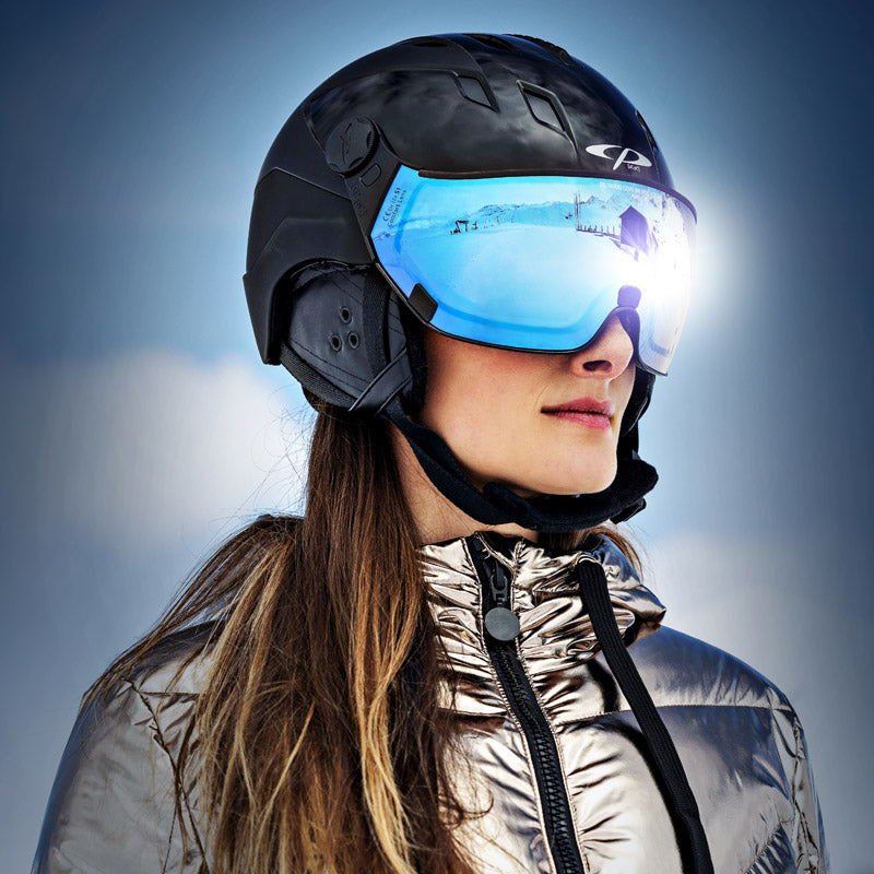 Closeup of woman wearing a black Corao+ model visor ski helmet from CP Sports