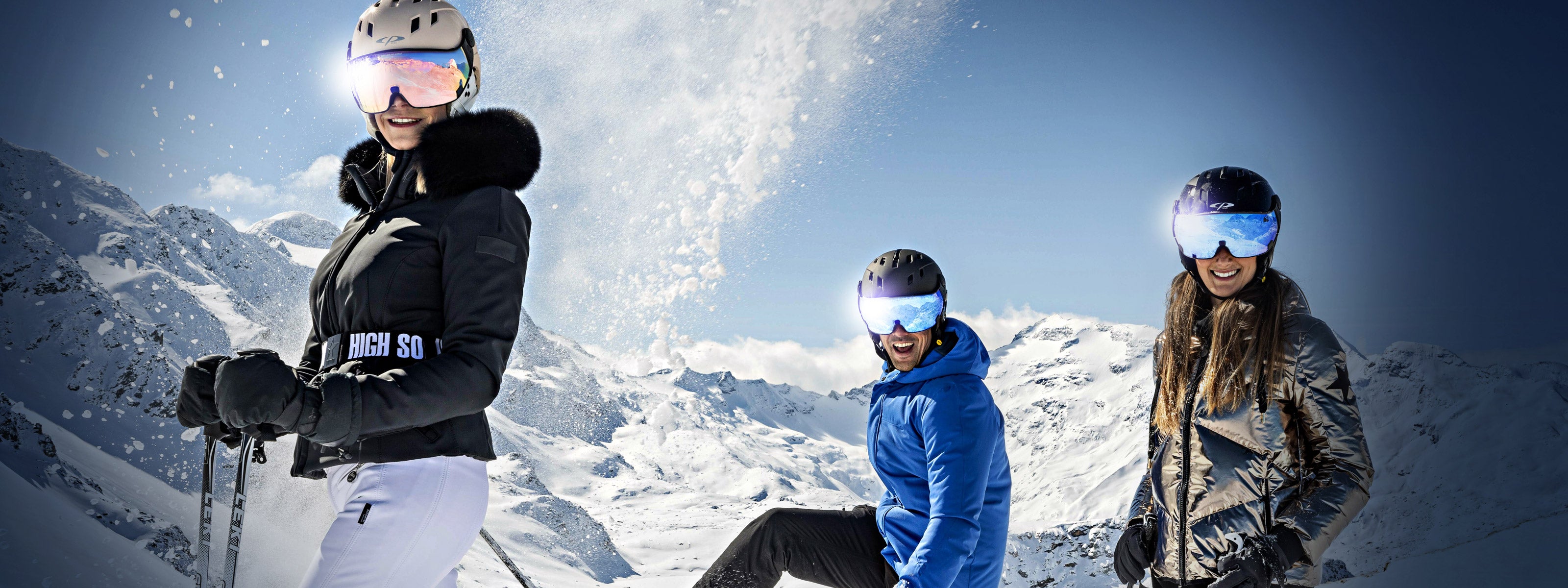three skiers with all in on ski helmets standing on a ski slope