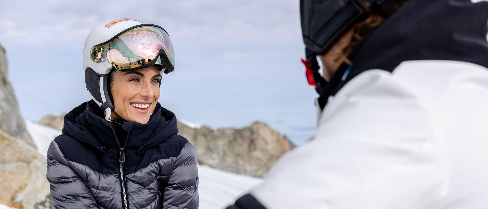 Woman wearing Kask Chrome visor ski helmet with rainbow lens visor