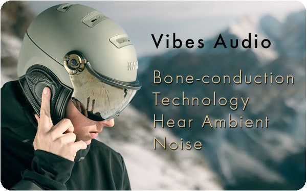 Man wearing green visor ski helmet from Kask with audio system