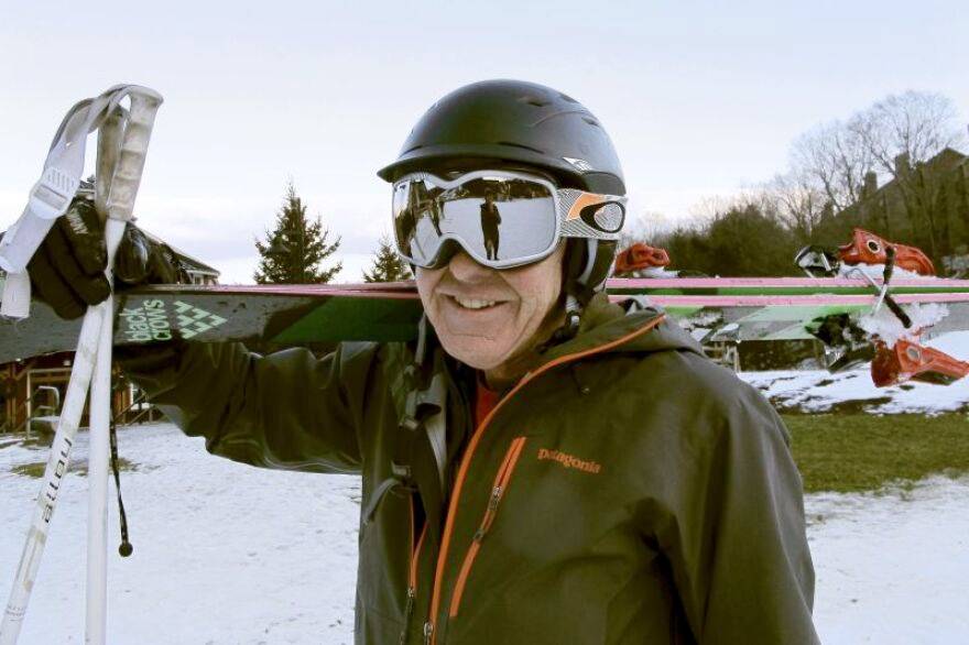 Picture of a man wearing a traditional ski helmet with goggles