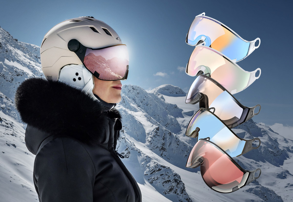 Woman wearing a CP Visor Ski Helmet and a selection of additional visors to change for light and snow conditions